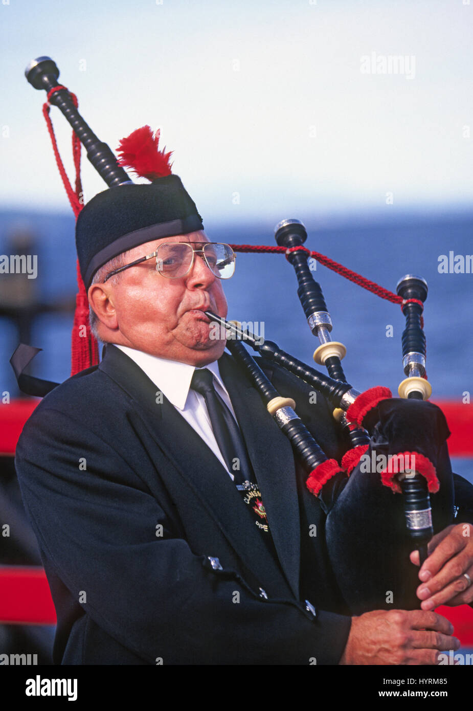 A man playing bagpipes plays during a Canada Day parade in a small village in western British Columbia, Canada Stock Photo