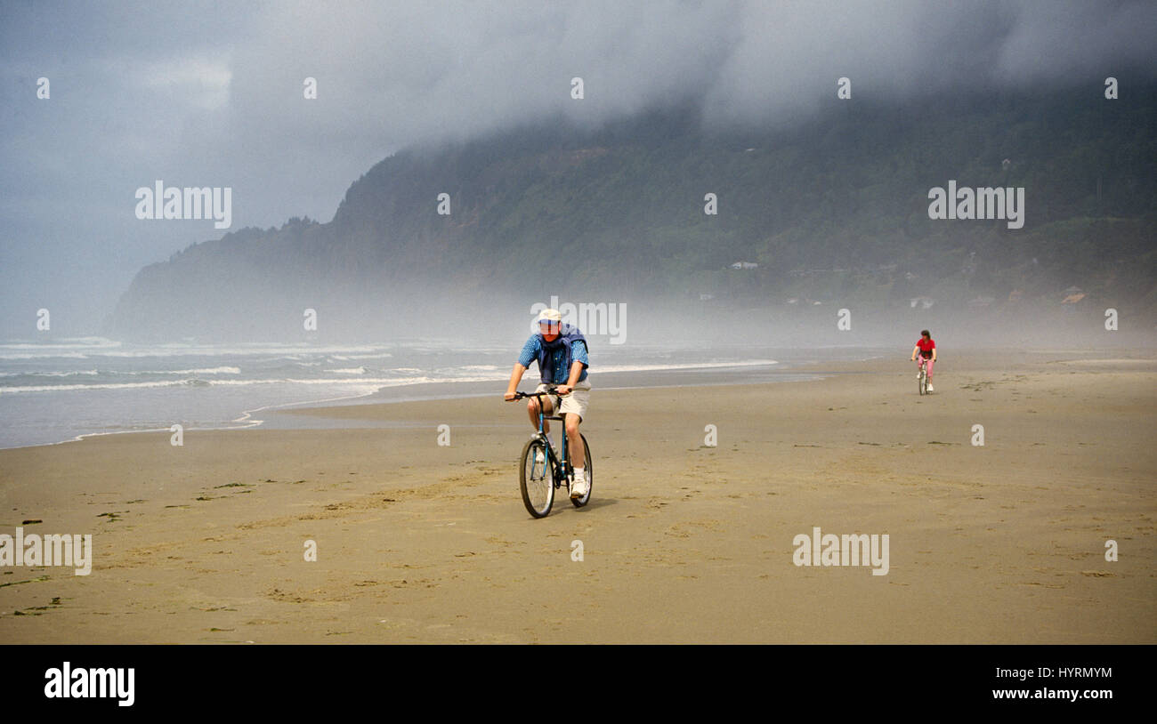 Unreleased. For editorial usage only. Bikers ride along the beach near Manzanita, Oregon Stock Photo