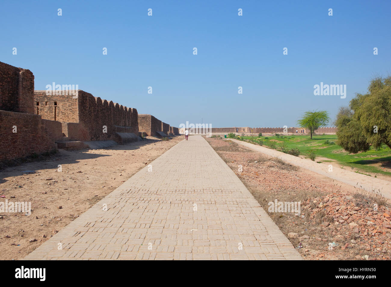 visitors at the historical site of bhatner fort in the town of hanumangarh rajasthan india with restored fort walls and paths under a clear blue sky Stock Photo