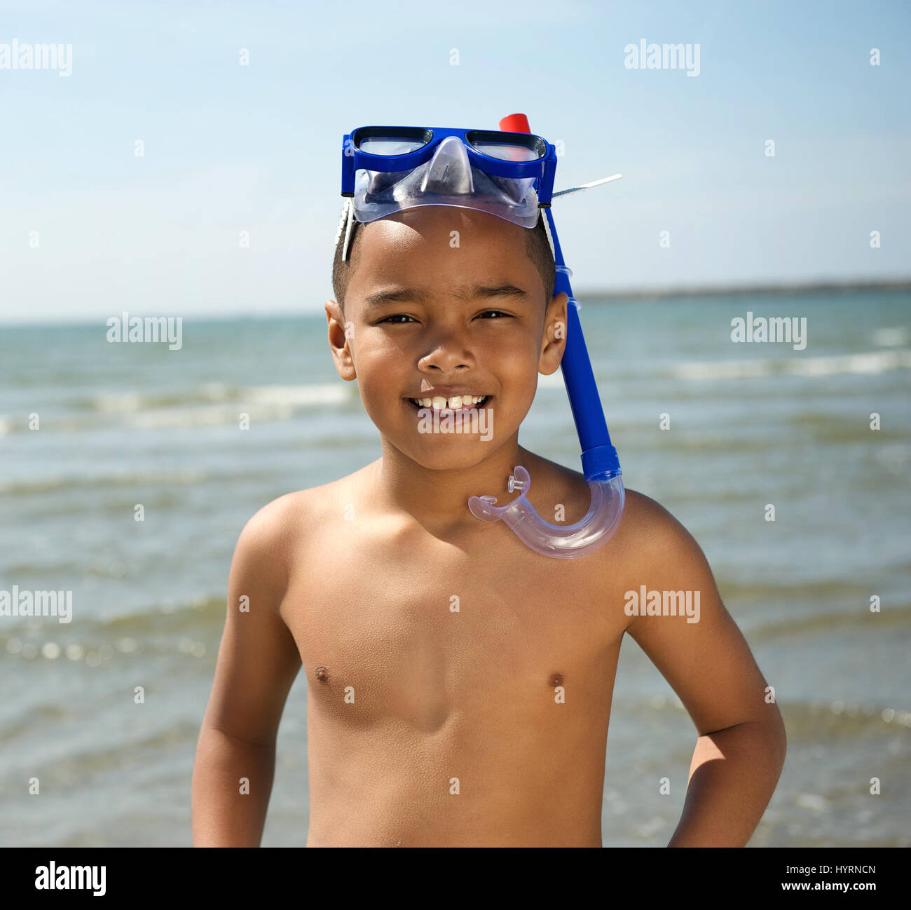 Close up portrait of a smiling little boy with snorkel by the sea Stock