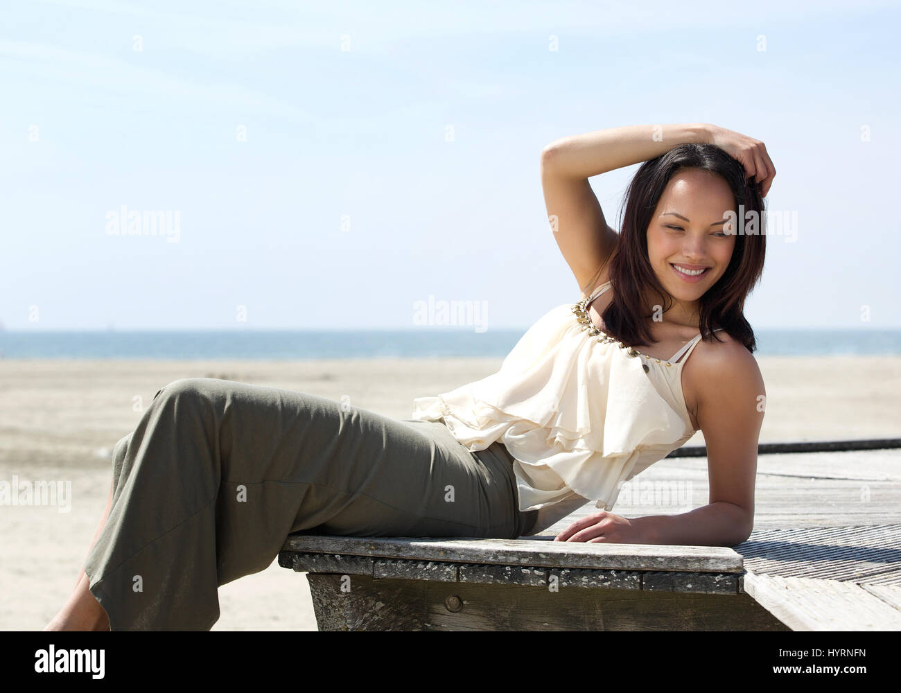 Portrait of a cheerful young asian woman posing outdoors with happy ...