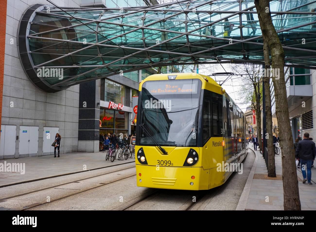 Metrolink trams in Corporation street, Manchester city centre passing the Arndale centre. Stock Photo