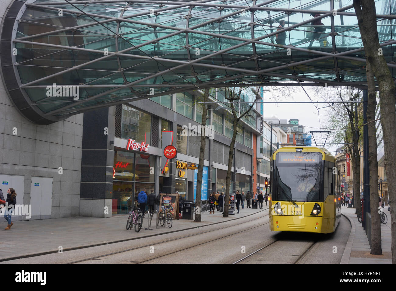 Metrolink trams in Corporation street, Manchester city centre passing the Arndale centre. Stock Photo