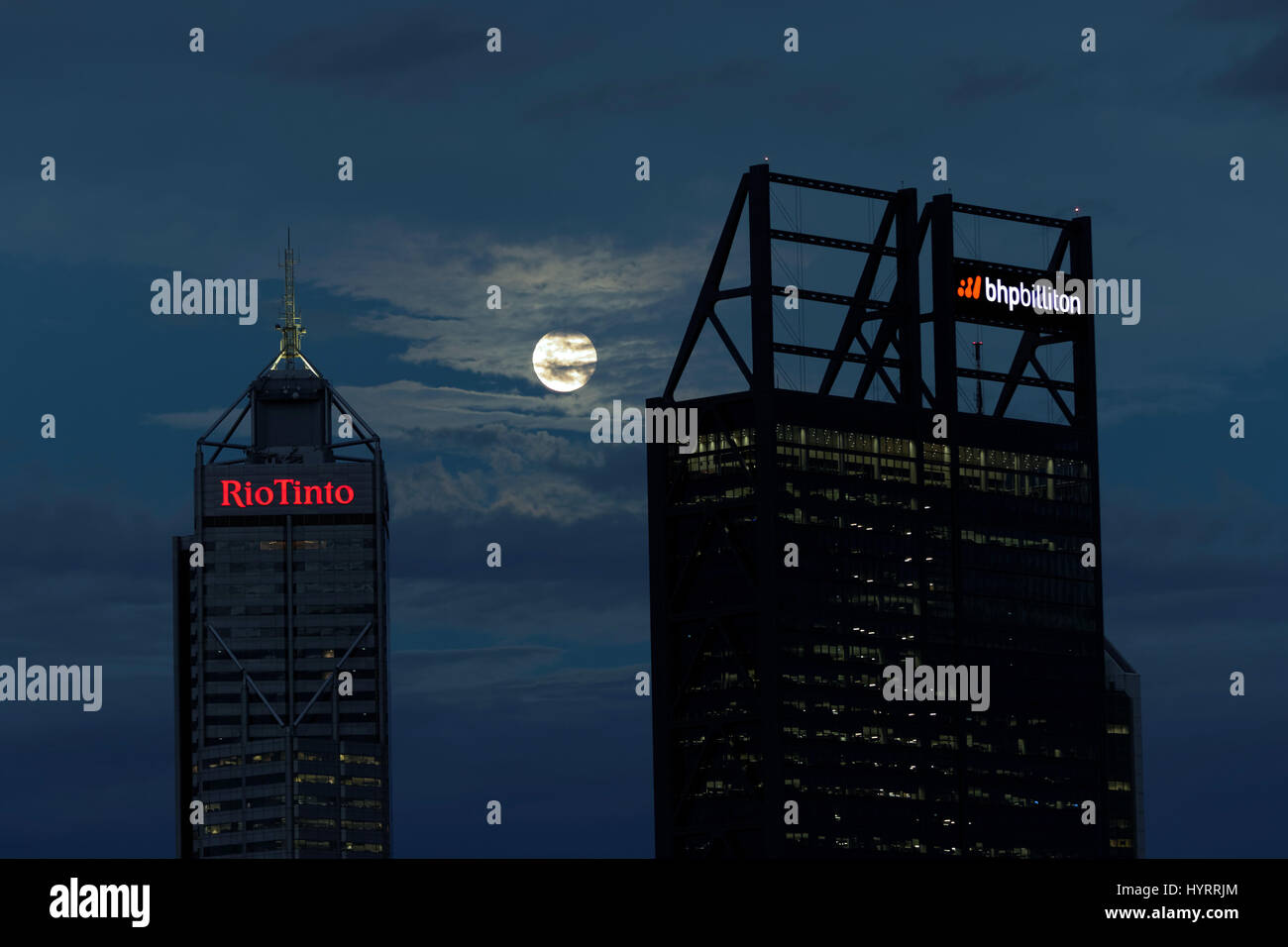 The full moon rises over the buildings occupied by mining companies BHP Blliton and Rio Tinto in Perth, Australia. Stock Photo