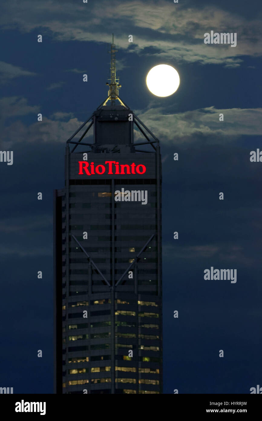 The full moon rises over the buildings occupied by mining company Rio Tinto in Perth, Australia. Stock Photo