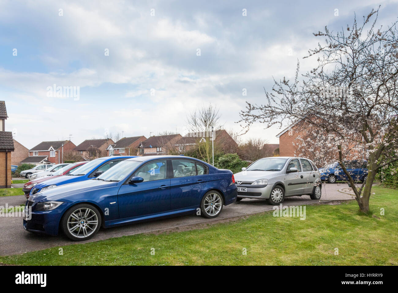 Car ownership. Many cars parked on driveways of a housing estate in Nottinghamshire, England, UK Stock Photo