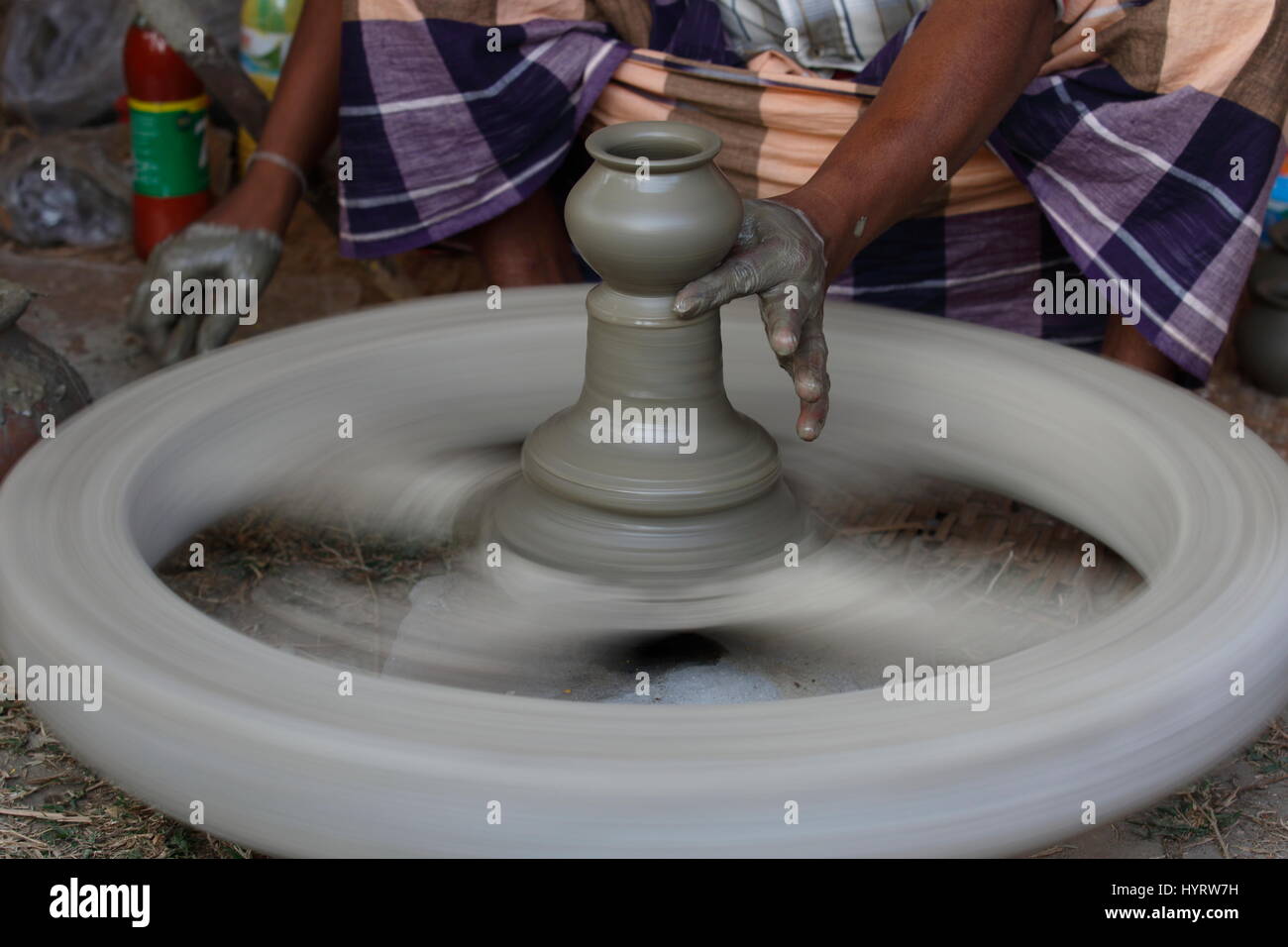 Potter makes clay pot using a traditional wheel at Sonargaon, Narayanganj,  Bangladesh. Stock Photo