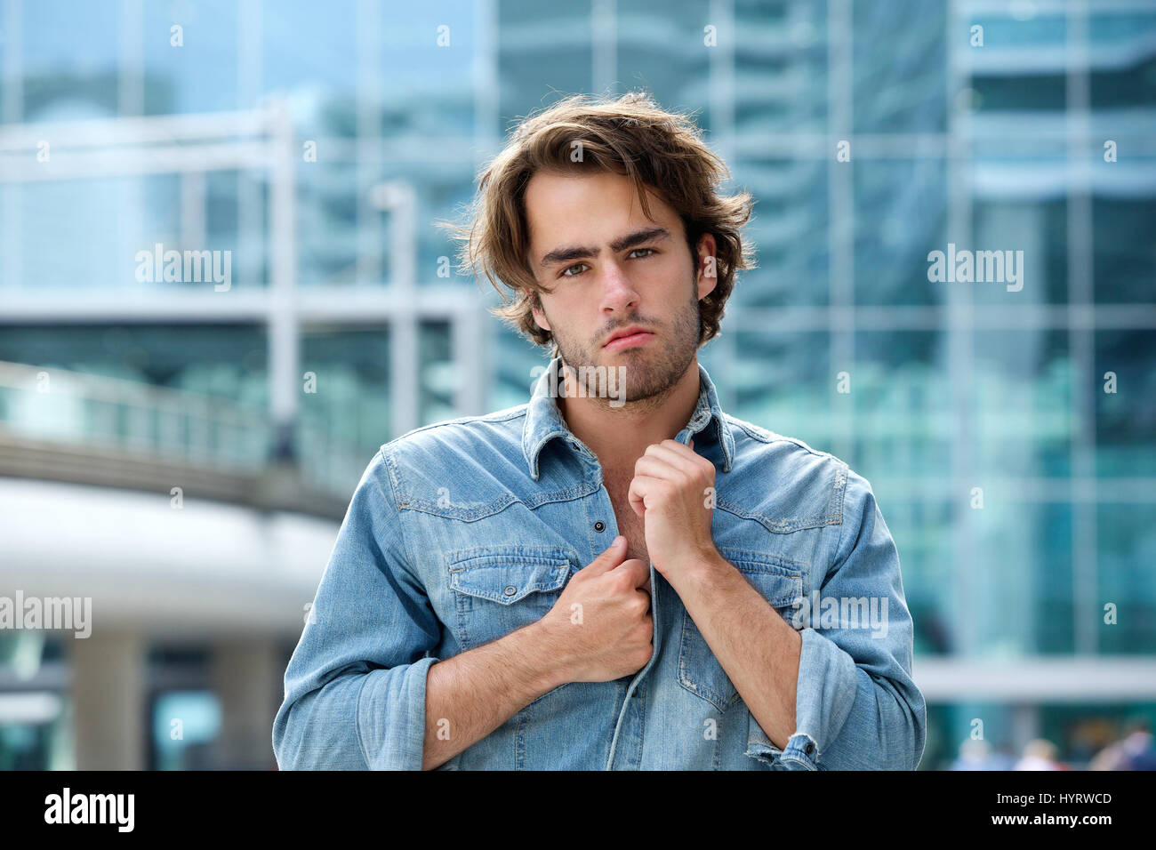 Close up portrait of a trendy young man posing outside Stock Photo - Alamy