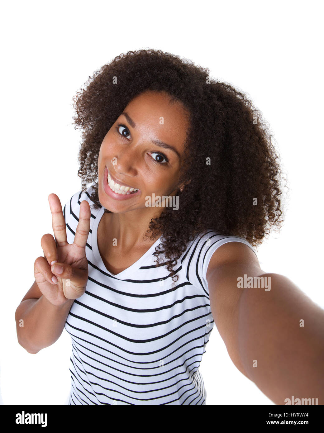 Self portrait of a happy young woman making selfie against isolated ...