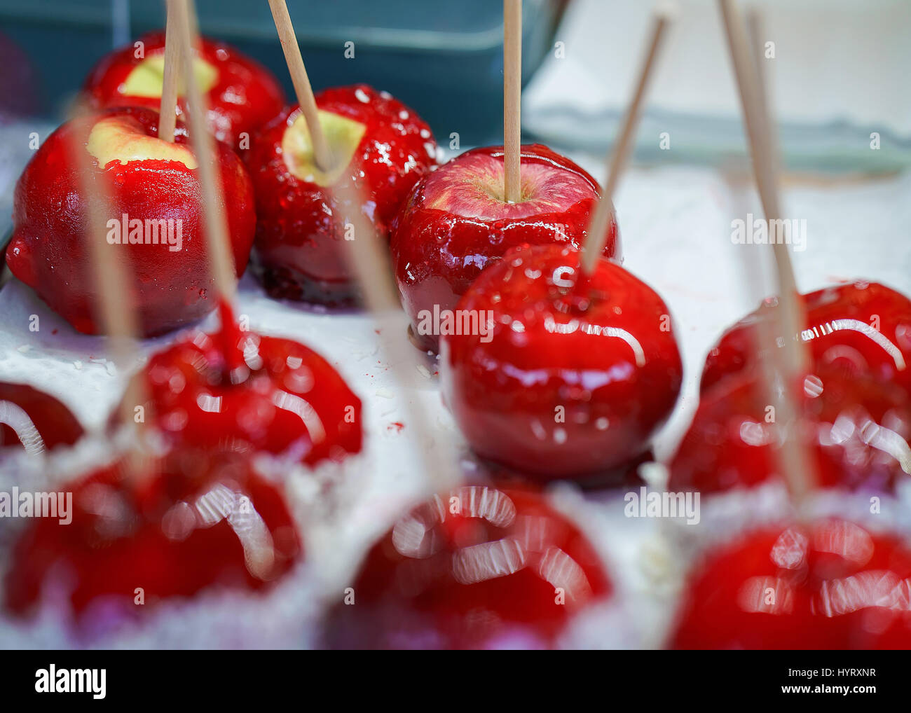 Stall with glazed lollipop apples which looks like cherry at the