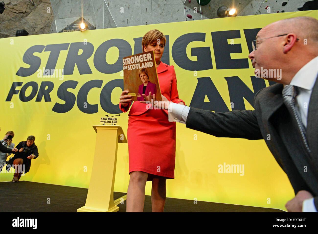 SNP leader and Scottish First Minister Nicola Sturgeon is handed a copy of the party's general election manifesto by her husband, SNP Chief Executive Peter Murrell at a launch event in Edinburgh Stock Photo