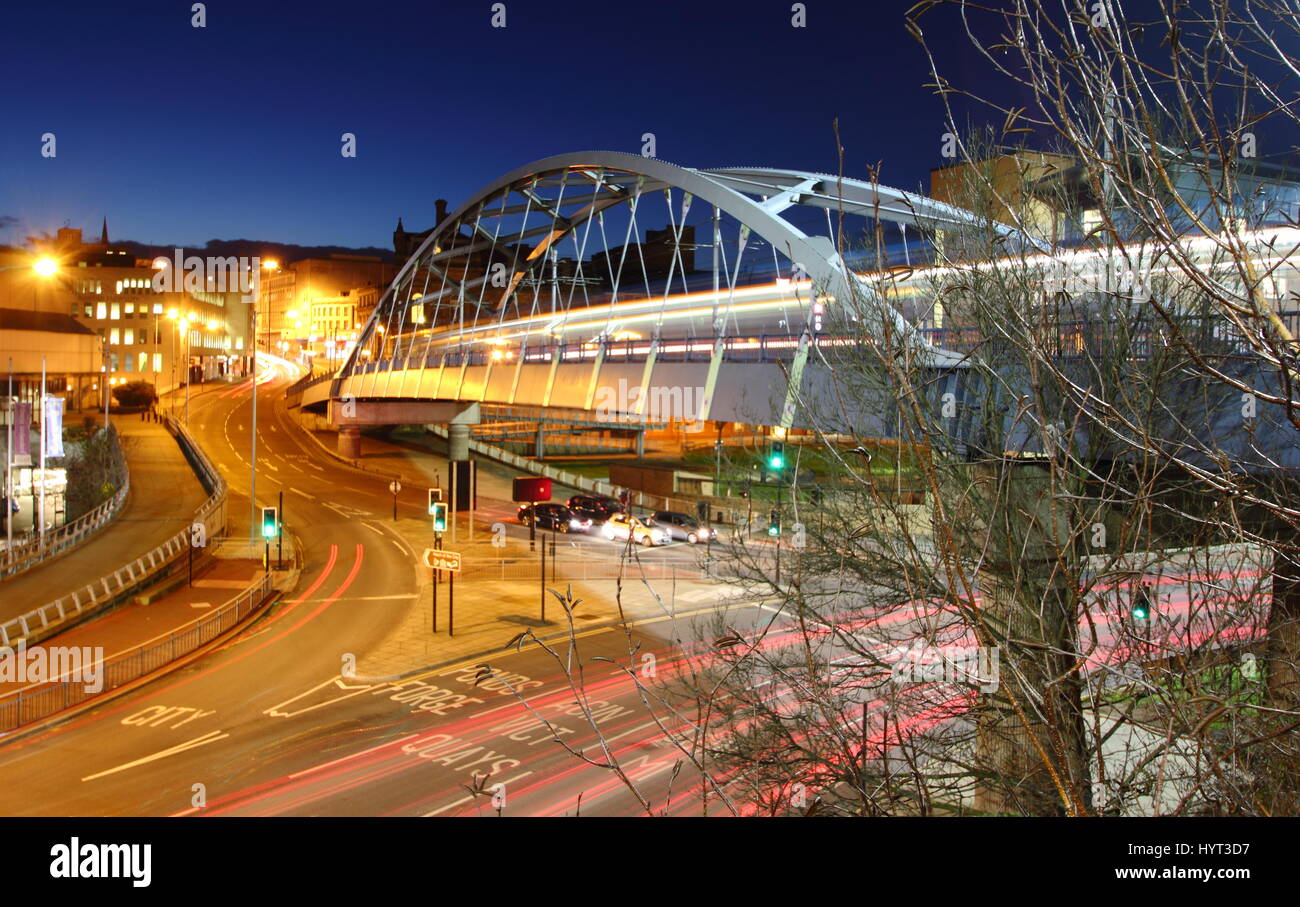 A tram passes over Park Square Bridge (Supertram Bridge), a prominent bridge in Sheffield city centre, Yorkshire, England UK - winter Stock Photo
