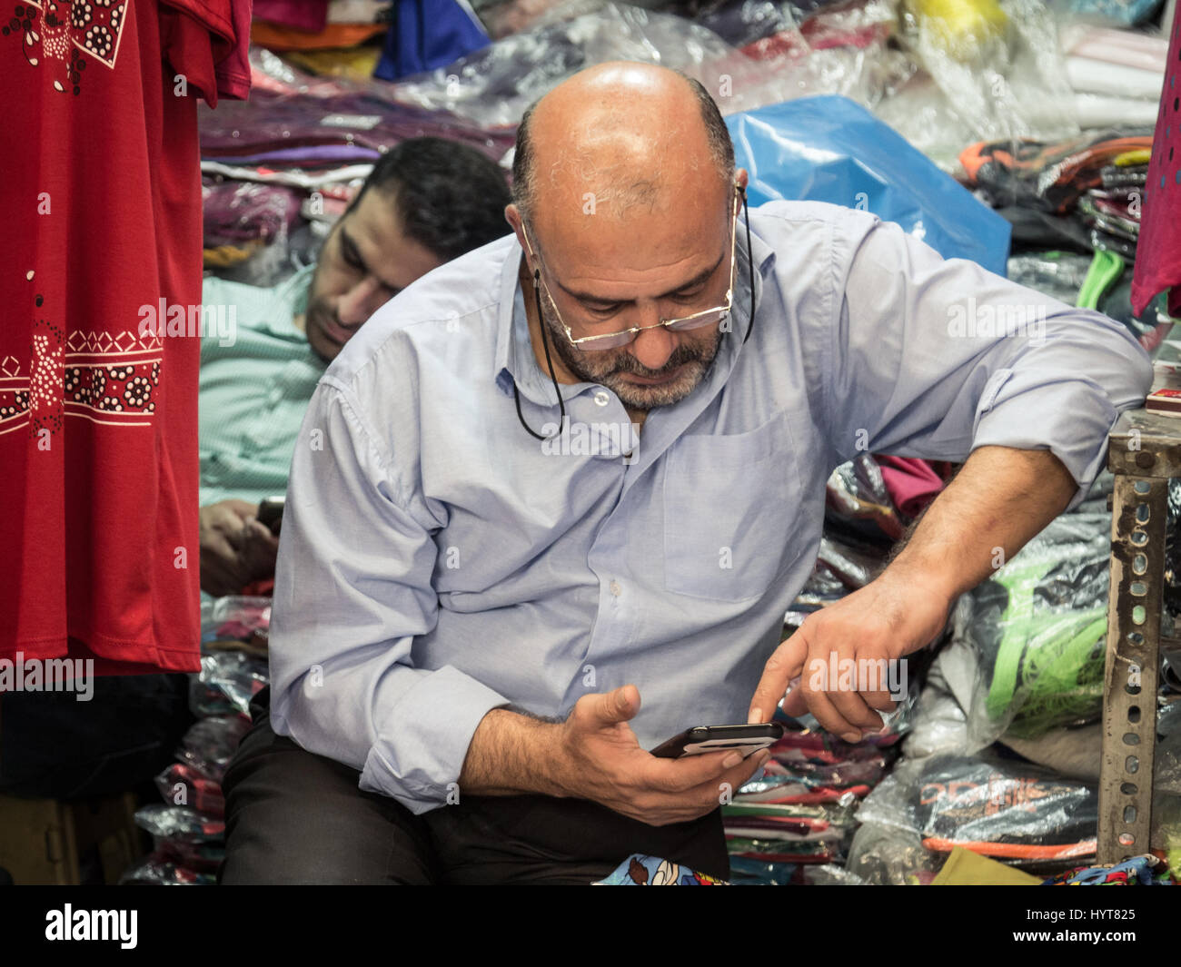 TEHRAN, IRAN - AUGUST 14, 2016: Iranian merchants using their smartphones in Tehran bazaar. Iran is among the first five countries which have had a gr Stock Photo