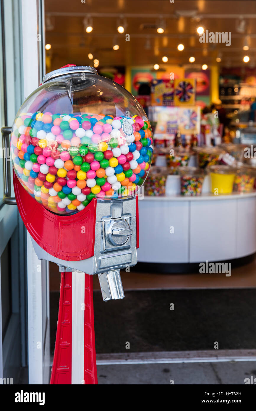 Colorful Gumball machine out in front of a candy store. Stock Photo