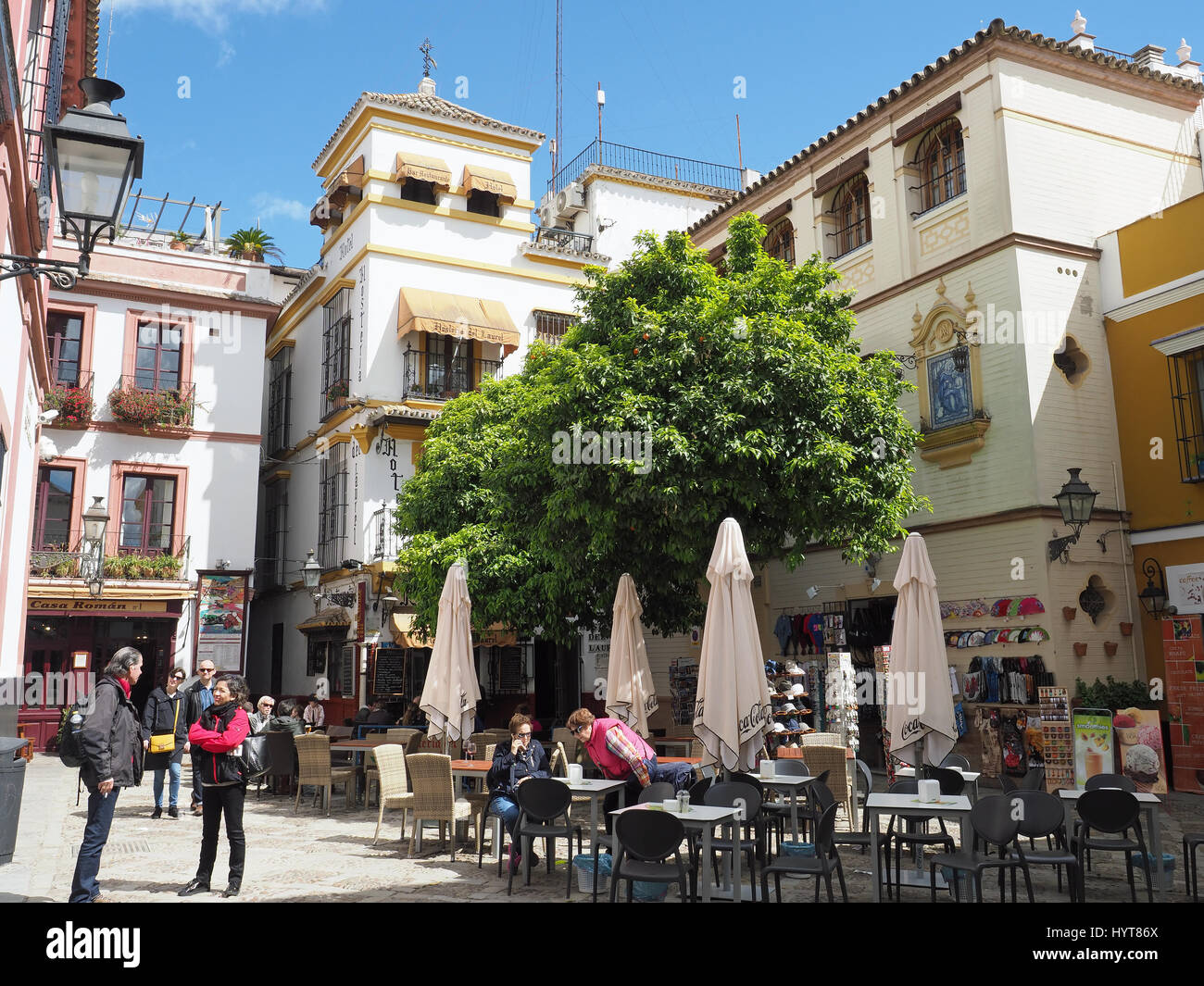 View of a leafy courtyard with a bar and restaurant in the old Barrio Santa Cruz district of Seville in Spain Stock Photo