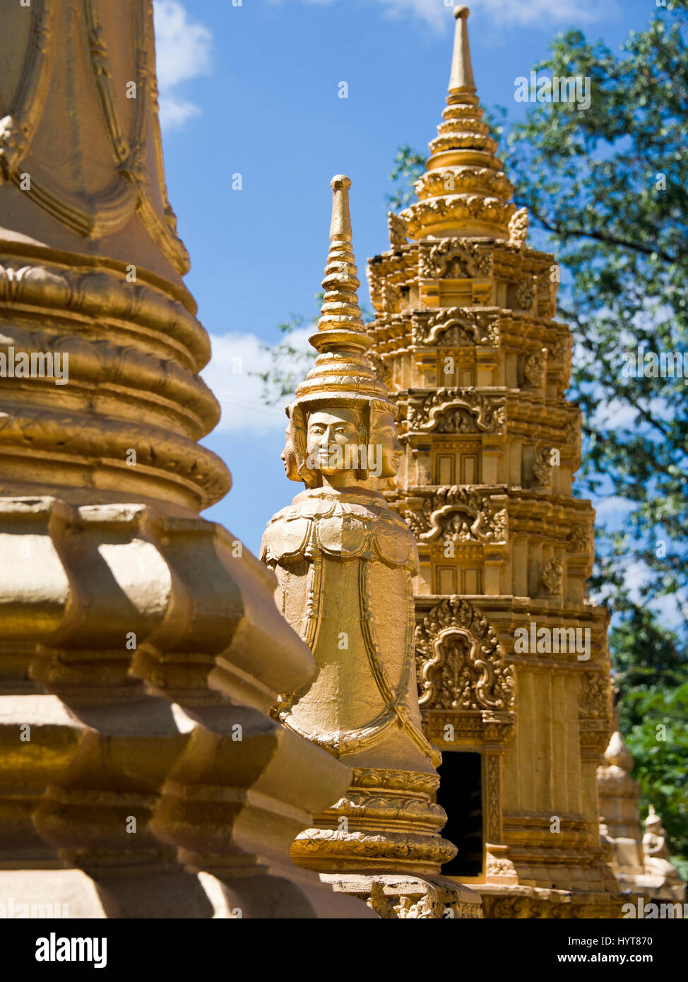 Vertical close up of gold statues at Wat Preah Prom Rath in Siem Reap, Cambodia. Stock Photo