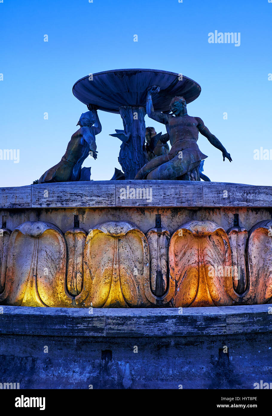 The view of the Tritons Fountain in Floriana at the entrance to the Valletta city in the evening light.  Malta. Stock Photo