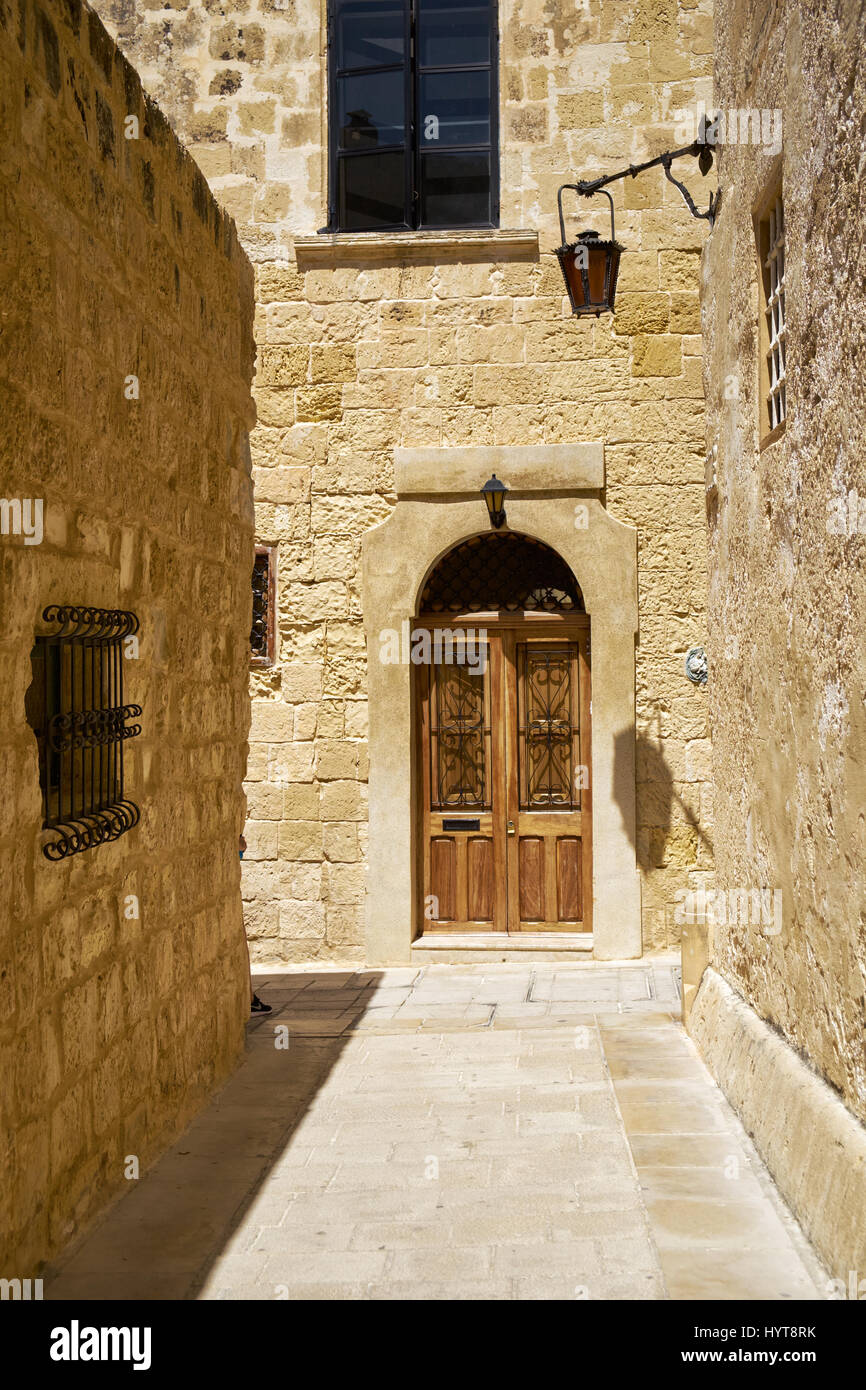 In the surroundings of limestone walls. The narrow medieval stone paved