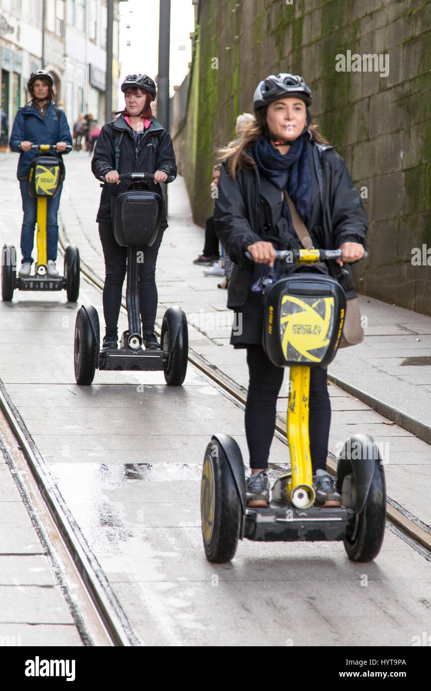 Real candid women having city tour on segways in Porto, Portugal. Vertical  crop with selective focus Stock Photo - Alamy