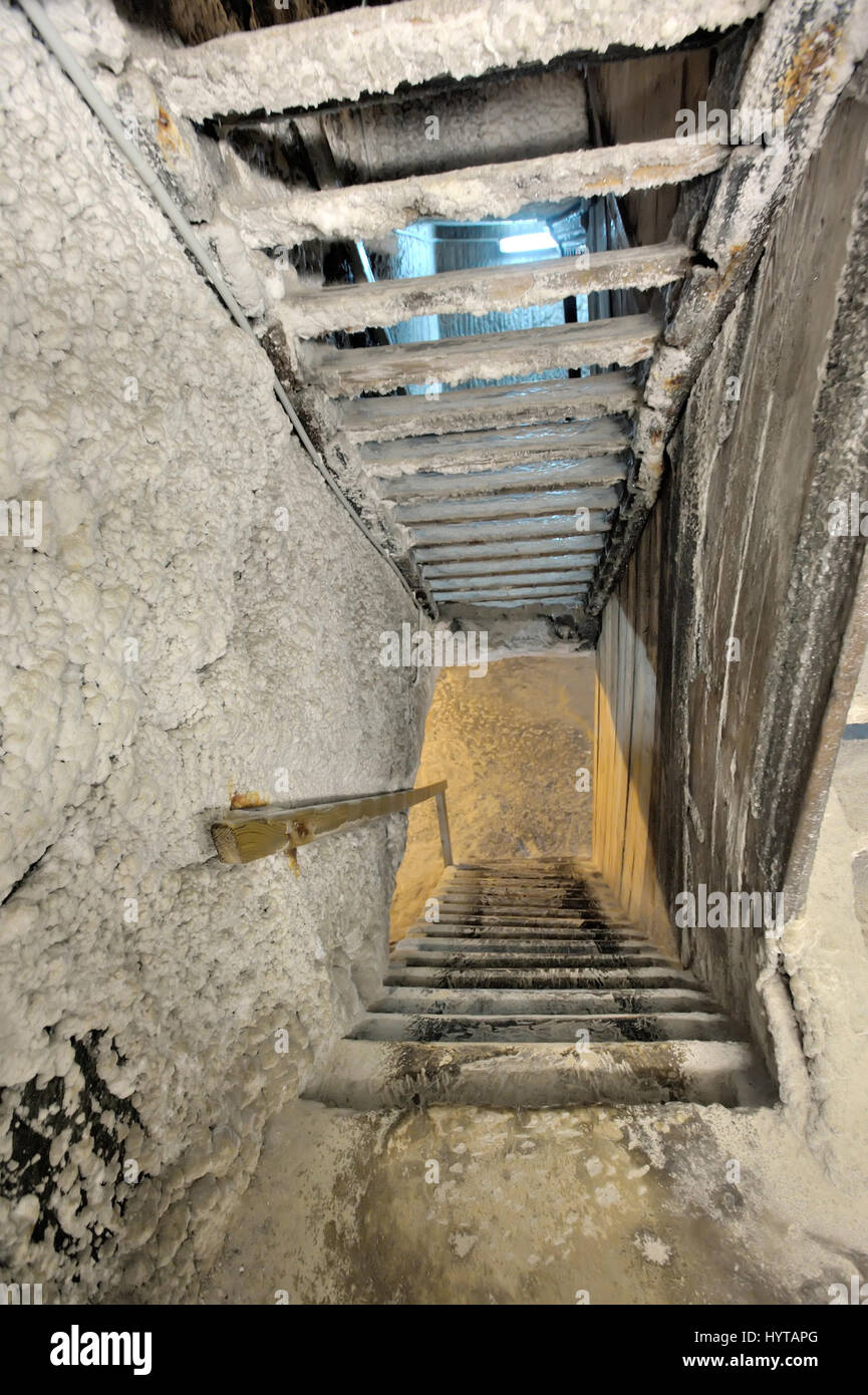 Old salt mine staircase covered with salt Stock Photo