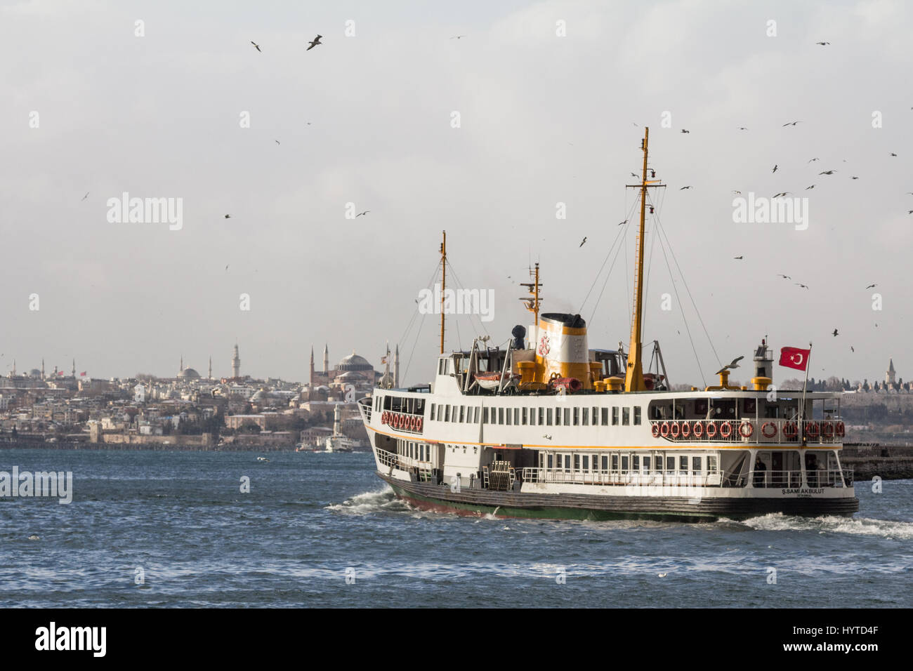 ISTANBUL, TURKEY - DECEMBER 30, 2015: Ferry leaving the port of Kadikoy district, Asian side of the city, heading to the European side, Ayasofya mosqu Stock Photo