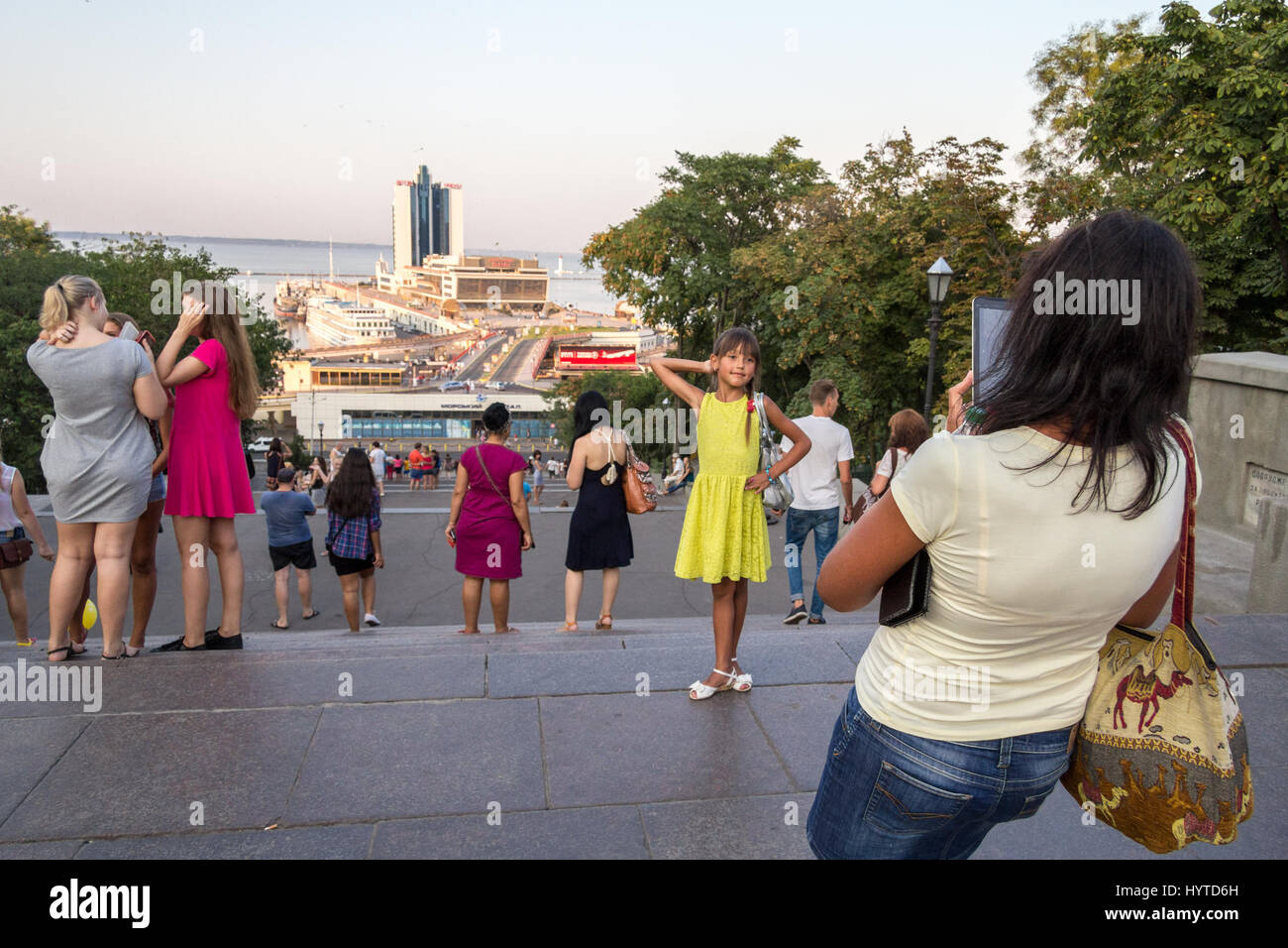 ODESSA, UKRAINE - AUGUST 14, 2015: Mother taking a picture of her daughter at the top of Potemkin stairs, one of the landmarks of Odessa, Ukraine  Pic Stock Photo