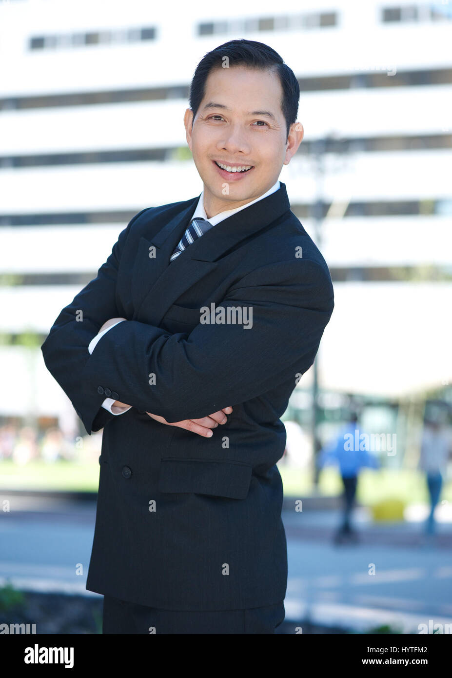 Portrait of a businessman standing outdoors with arms crossed Stock ...