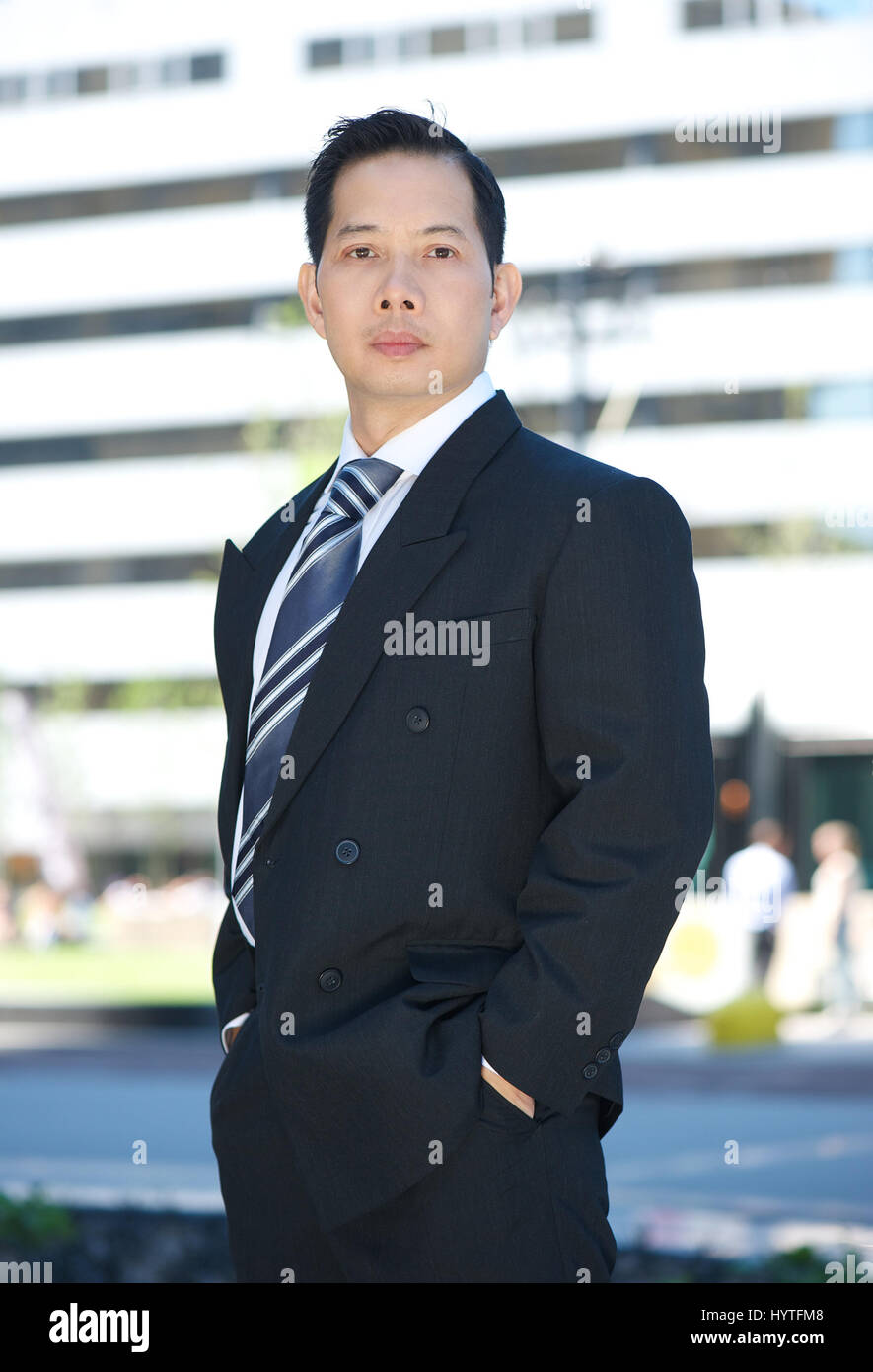 Formal portrait of an asian businessman standing outside Stock Photo