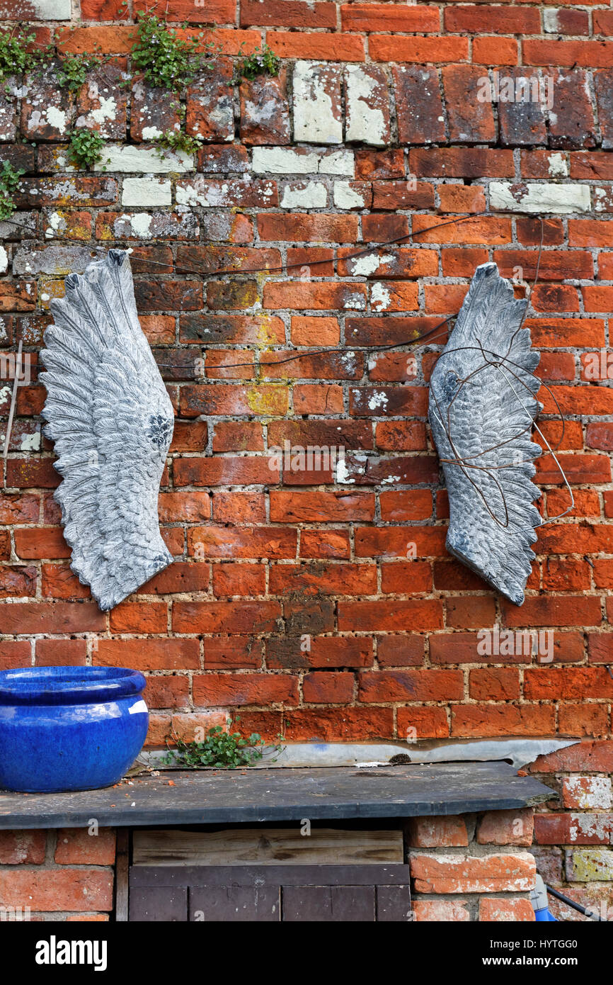 Angel's wings hanging on a red brick wall background Stock Photo Alamy