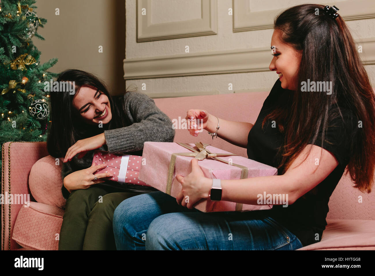 beautiful young girls having fun gifts to share. studio horizontal Photo. Stock Photo