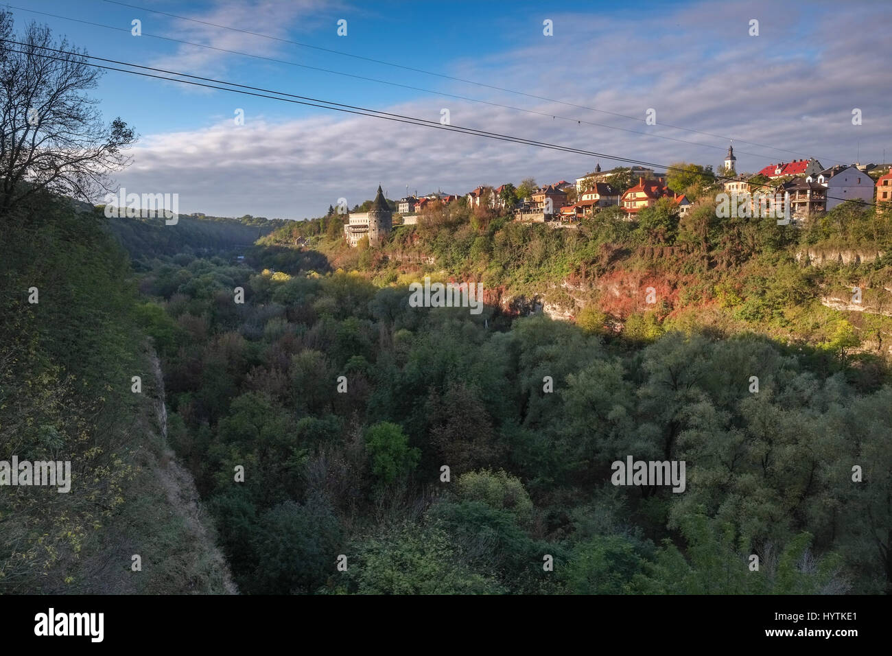 A watchtower above the canyon of the Smotrych River in Kamianets-Podilskyi, Western Ukraine. Trees are showing their autumn colours. Stock Photo