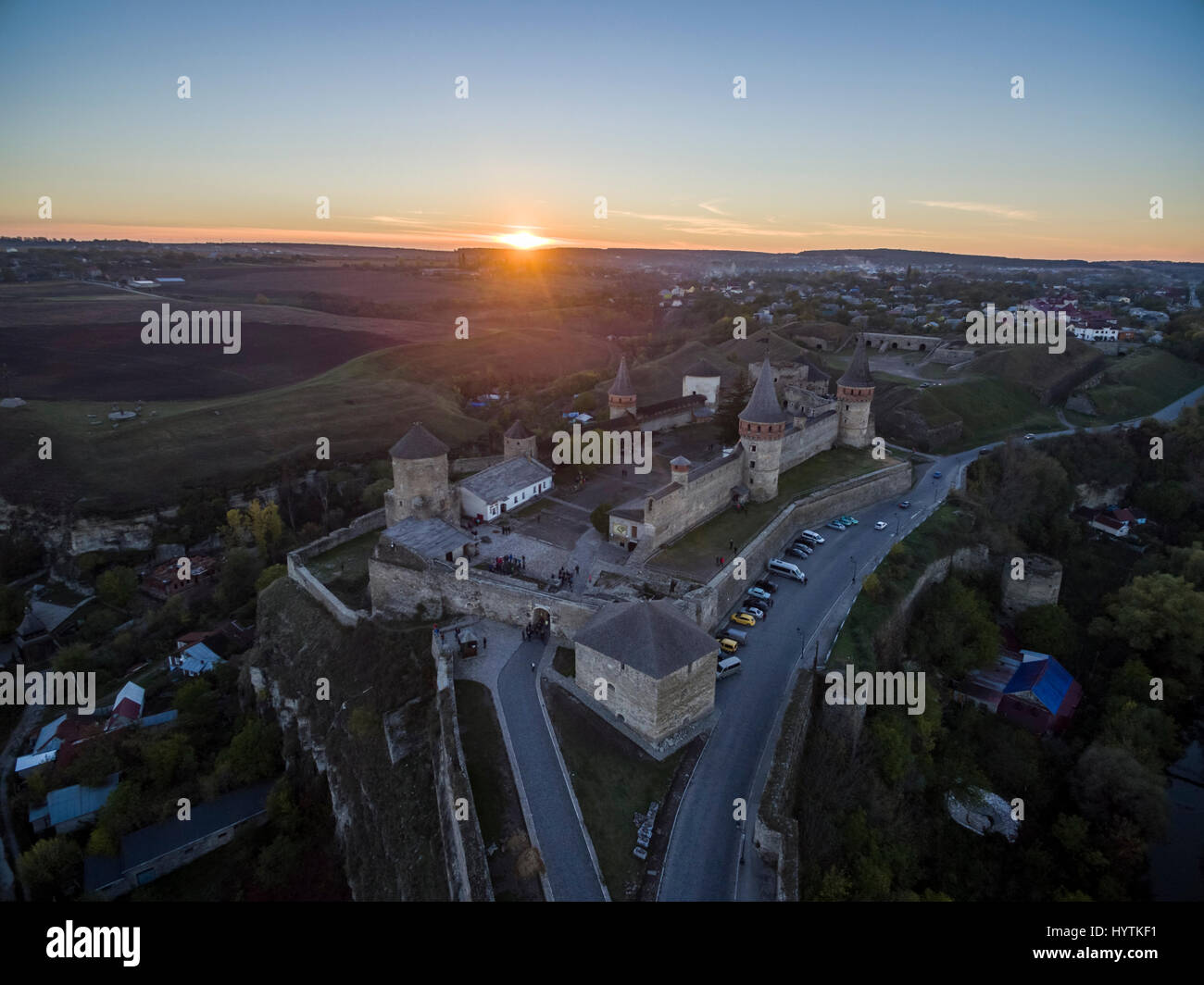 Aerial shot towards a sunset behind Kamianets-Podilskyi castle in Western Ukraine. Taken on a clear autumn evening Stock Photo