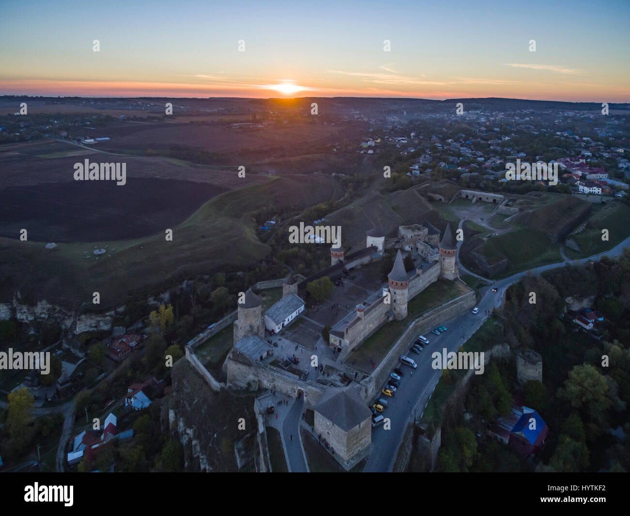 Aerial shot towards a sunset behind Kamianets-Podilskyi castle in Western Ukraine. Taken on a clear autumn evening Stock Photo