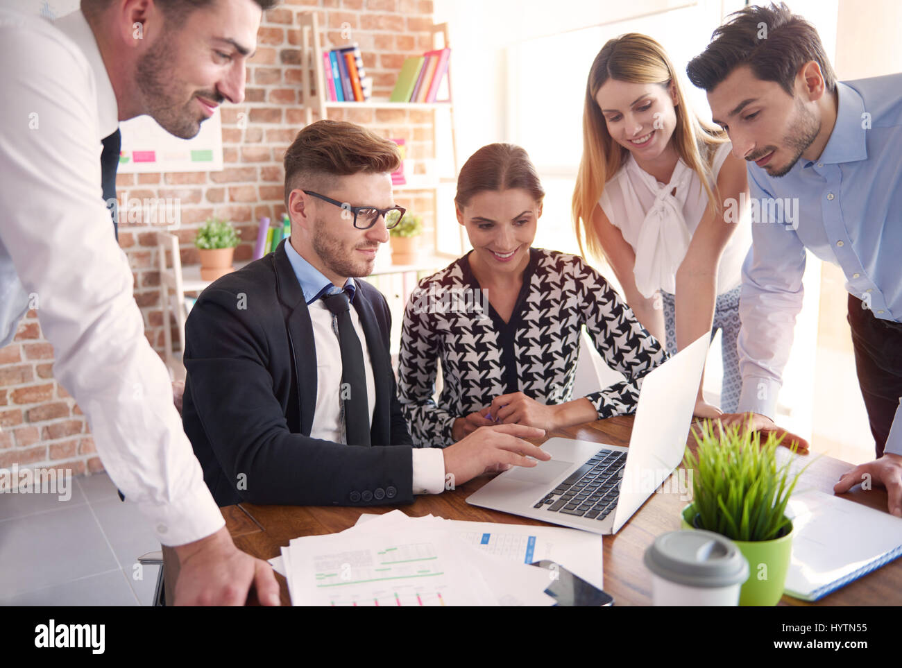 Workers gathered around the table Stock Photo