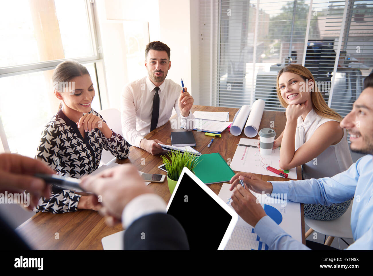 Cheerful office workers around the table Stock Photo Alamy