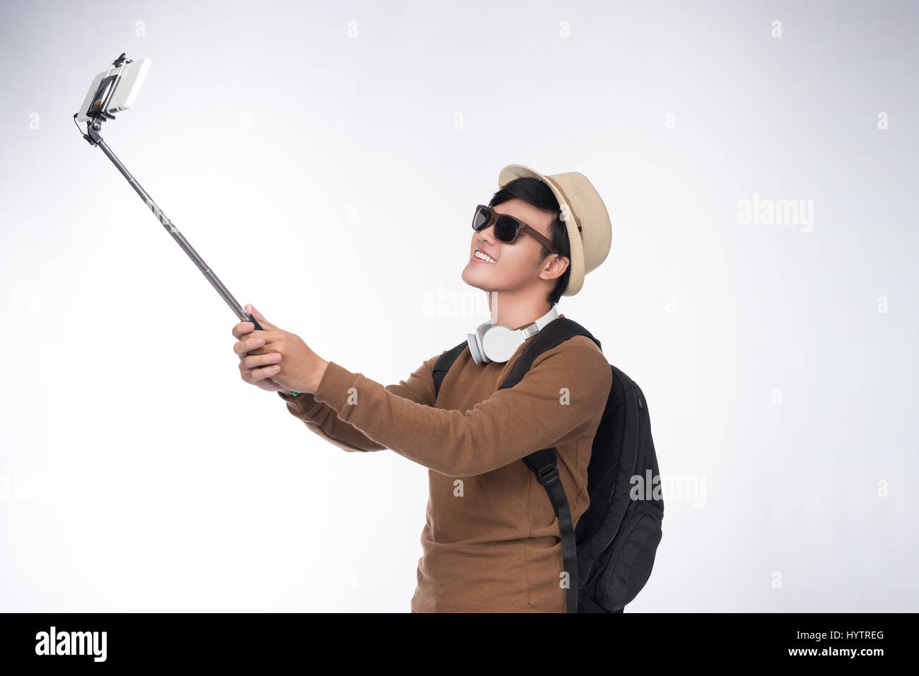 Happy young asian man taking self portrait photography through smart phone Stock Photo