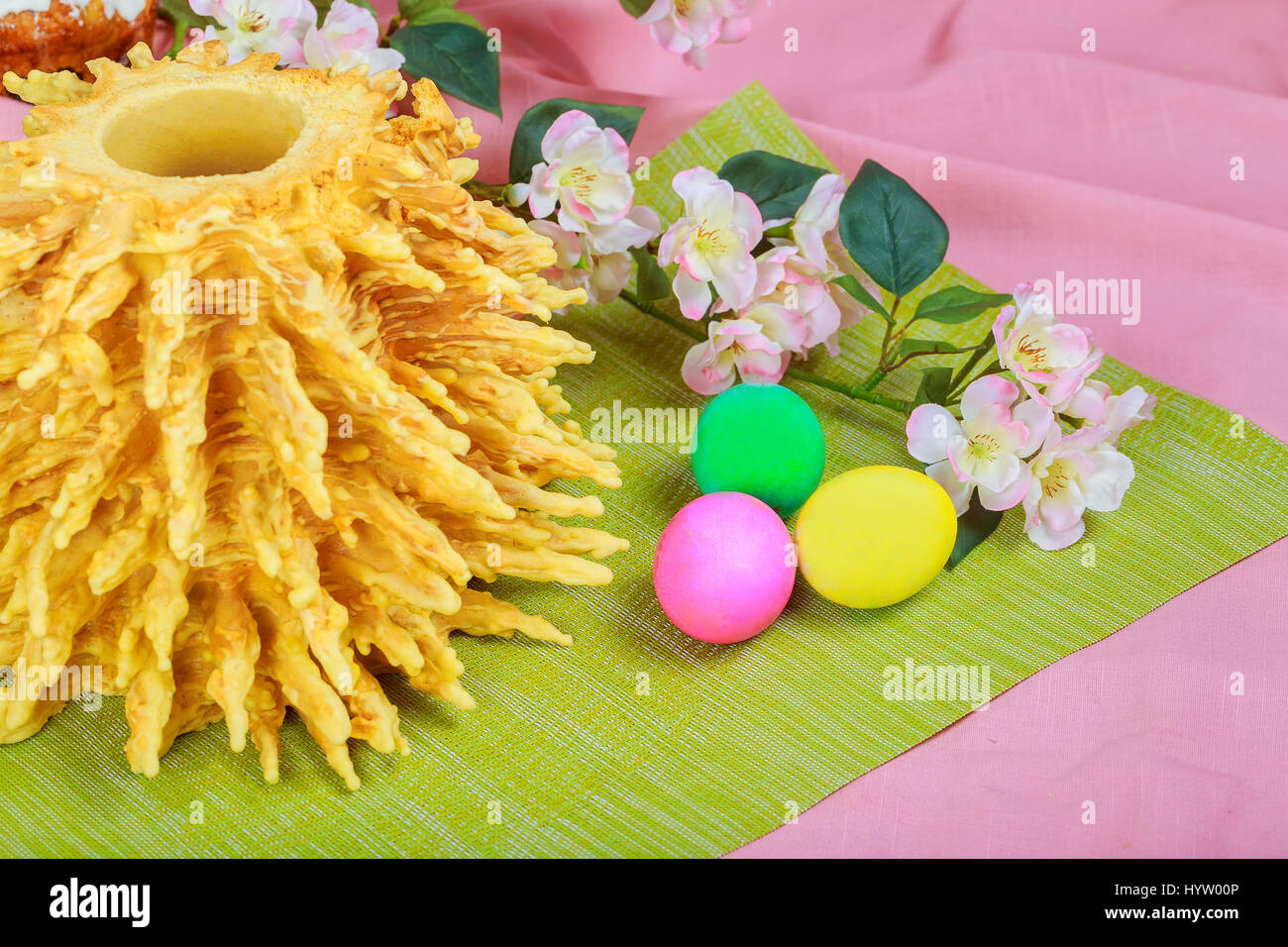 Homemade traditional easter LITHUANIAN SAKOTIS CAKE colored eggs on painted towel Stock Photo