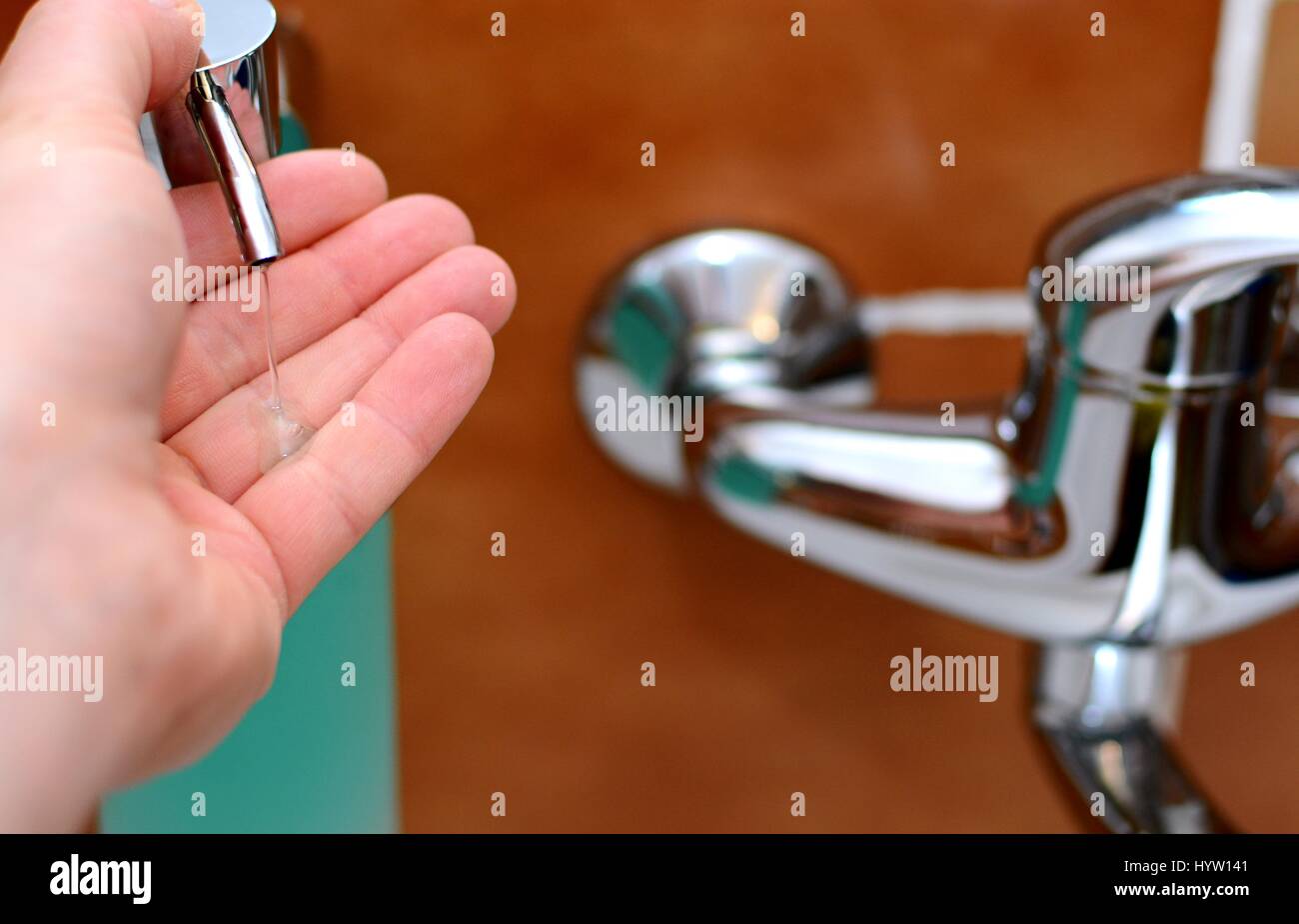 Pushing the Soap Dispenser for Dispensing a Soap Into the Palm. Stock Photo