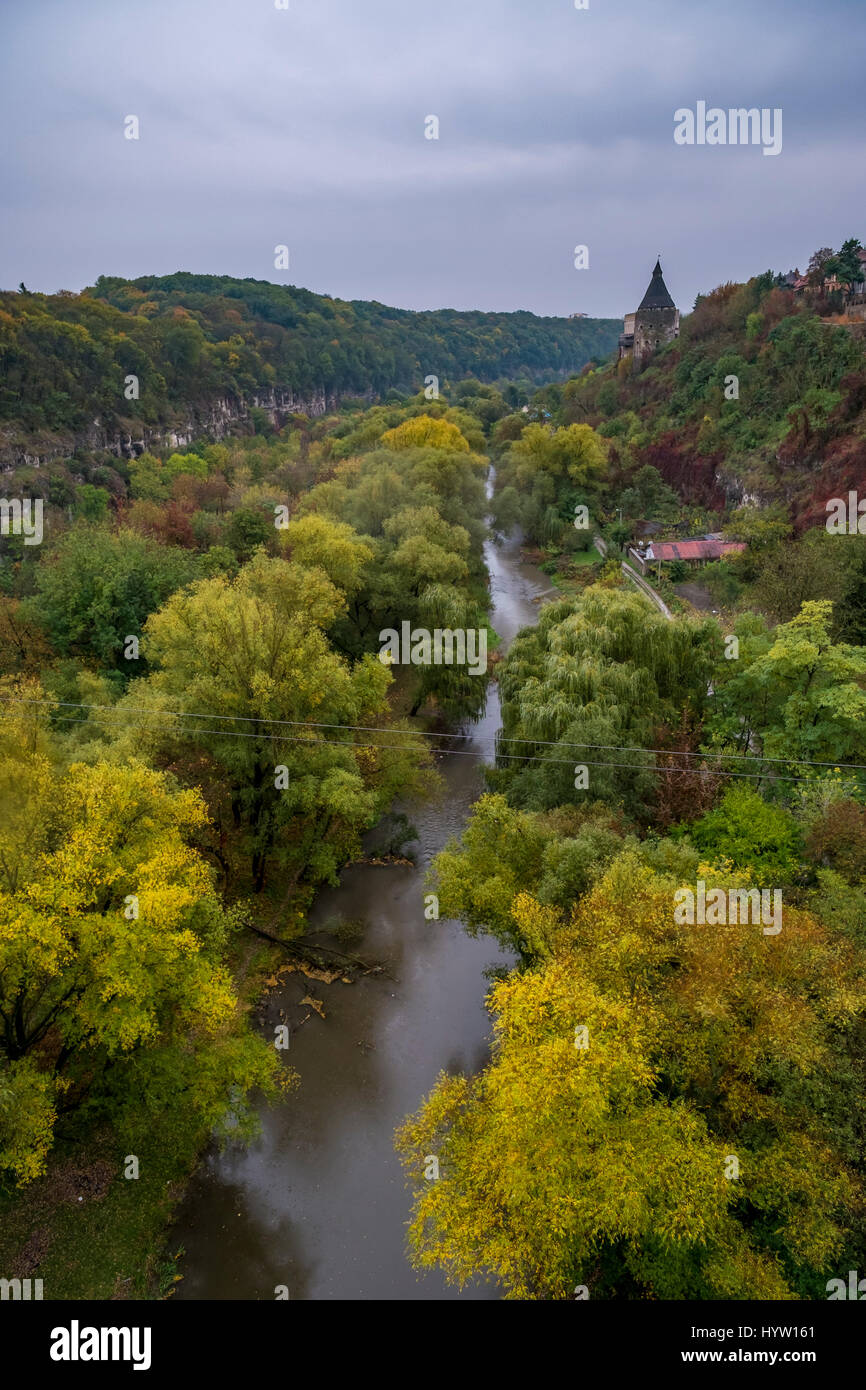 A watchtower above the canyon of the Smotrych River in Kamianets-Podilskyi, Western Ukraine. Trees are showing their autumn colours. Stock Photo