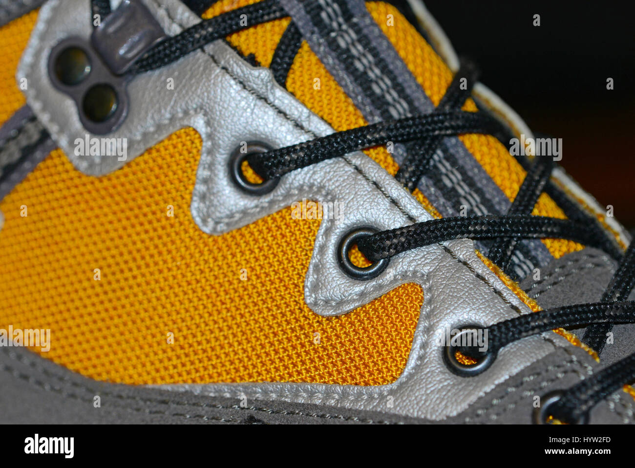 Waterproof leather and synthetic hiking boots closeup wih shoelaces