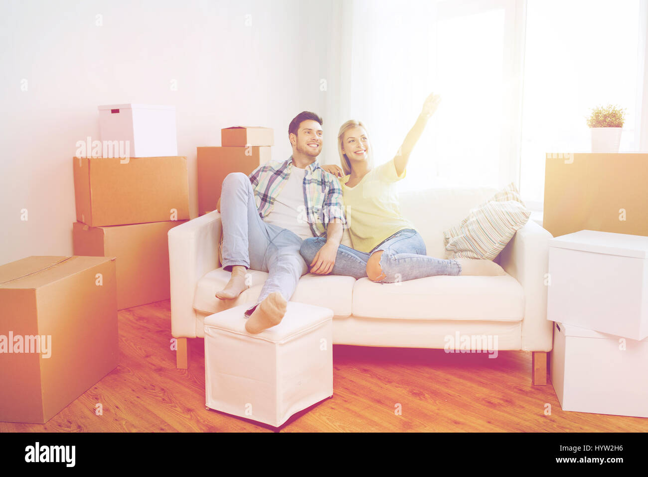 couple with boxes moving to new home and dreaming Stock Photo - Alamy