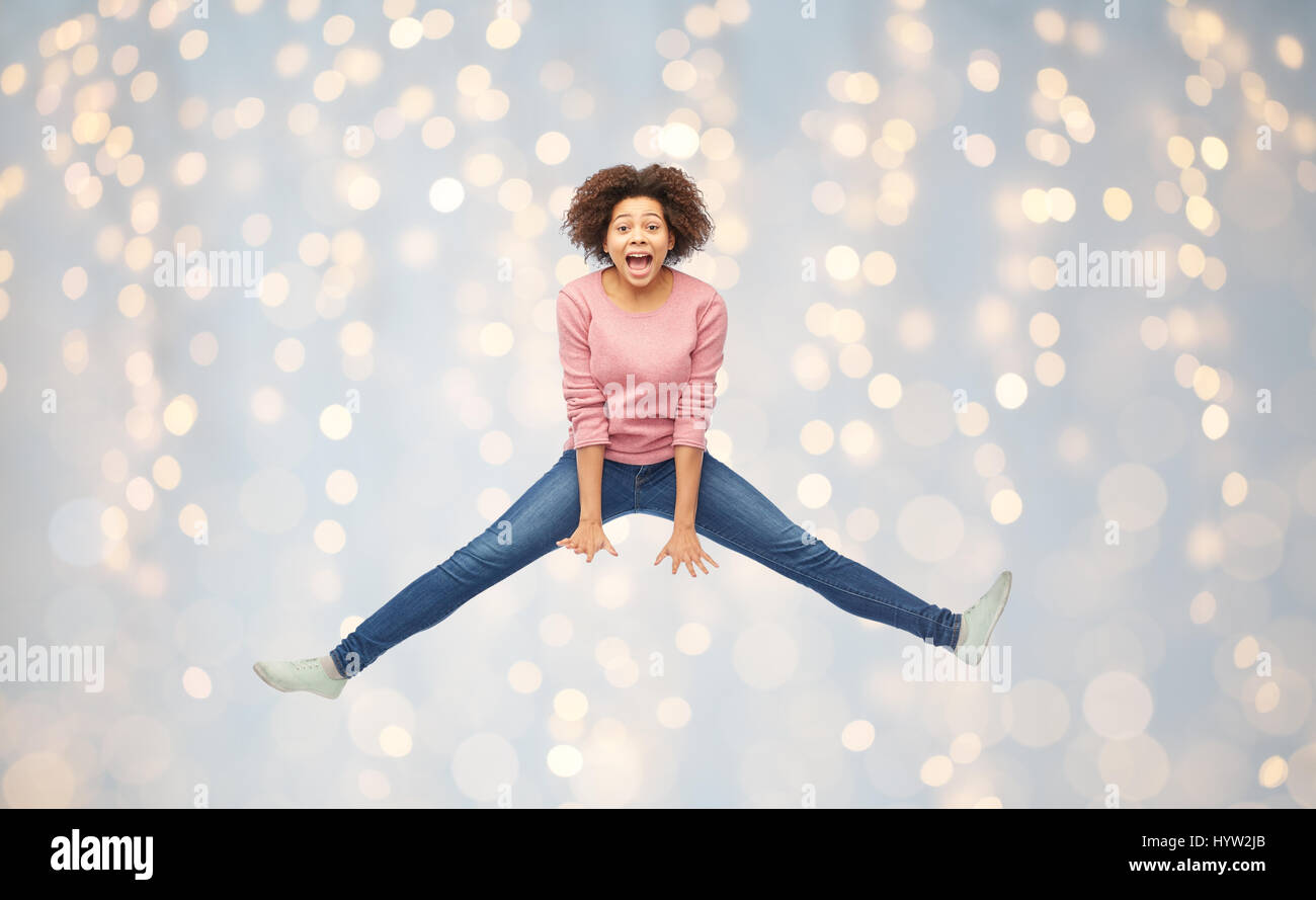 happy african american woman jumping over white Stock Photo - Alamy