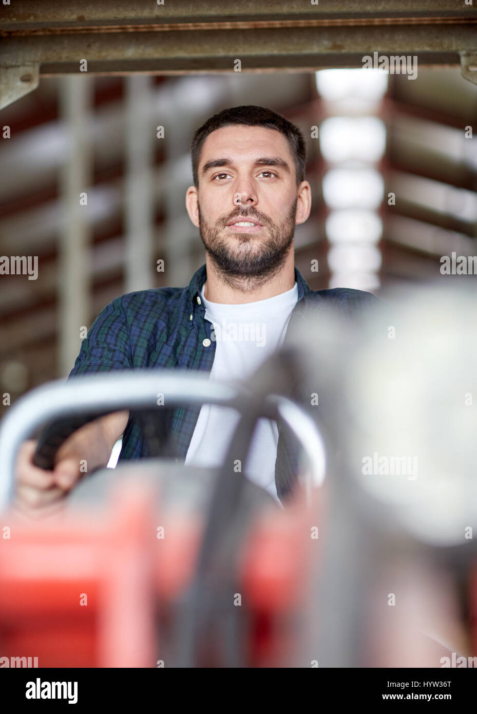 man or farmer driving tractor at farm Stock Photo - Alamy