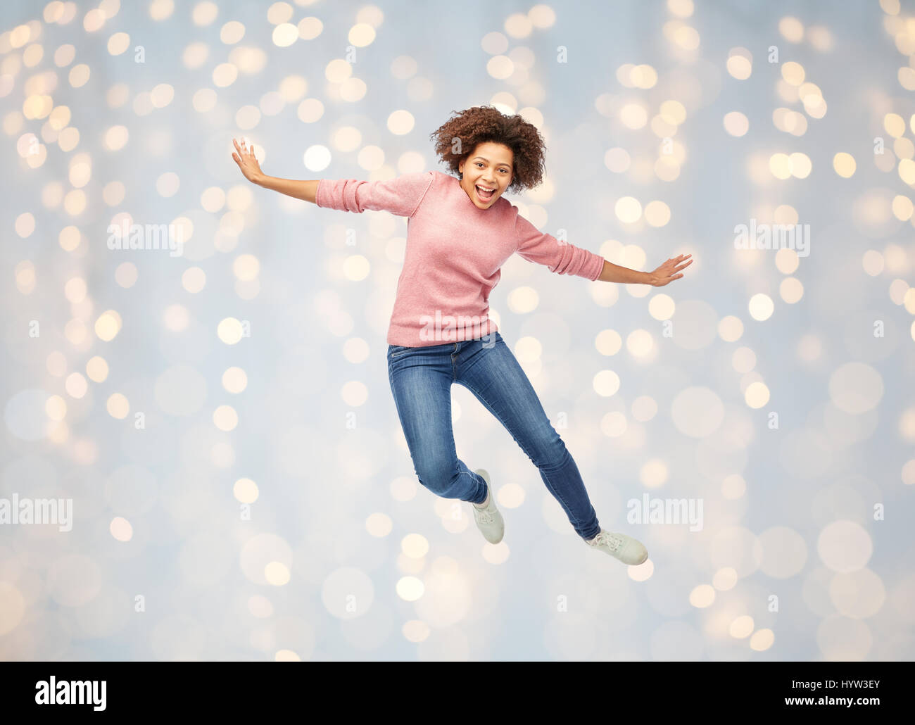 happy african american woman jumping over white Stock Photo - Alamy