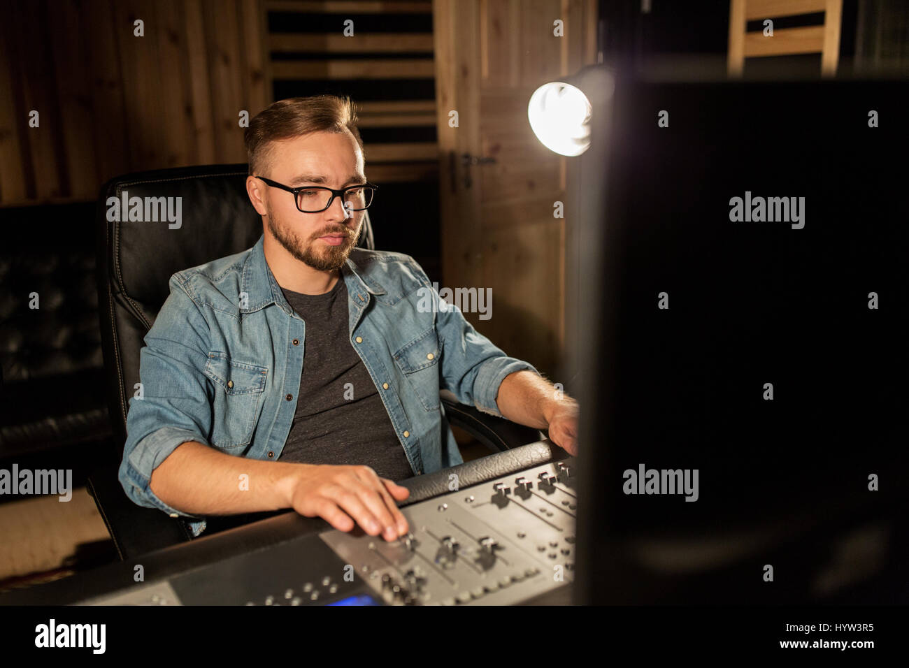 man at mixing console in music recording studio Stock Photo - Alamy