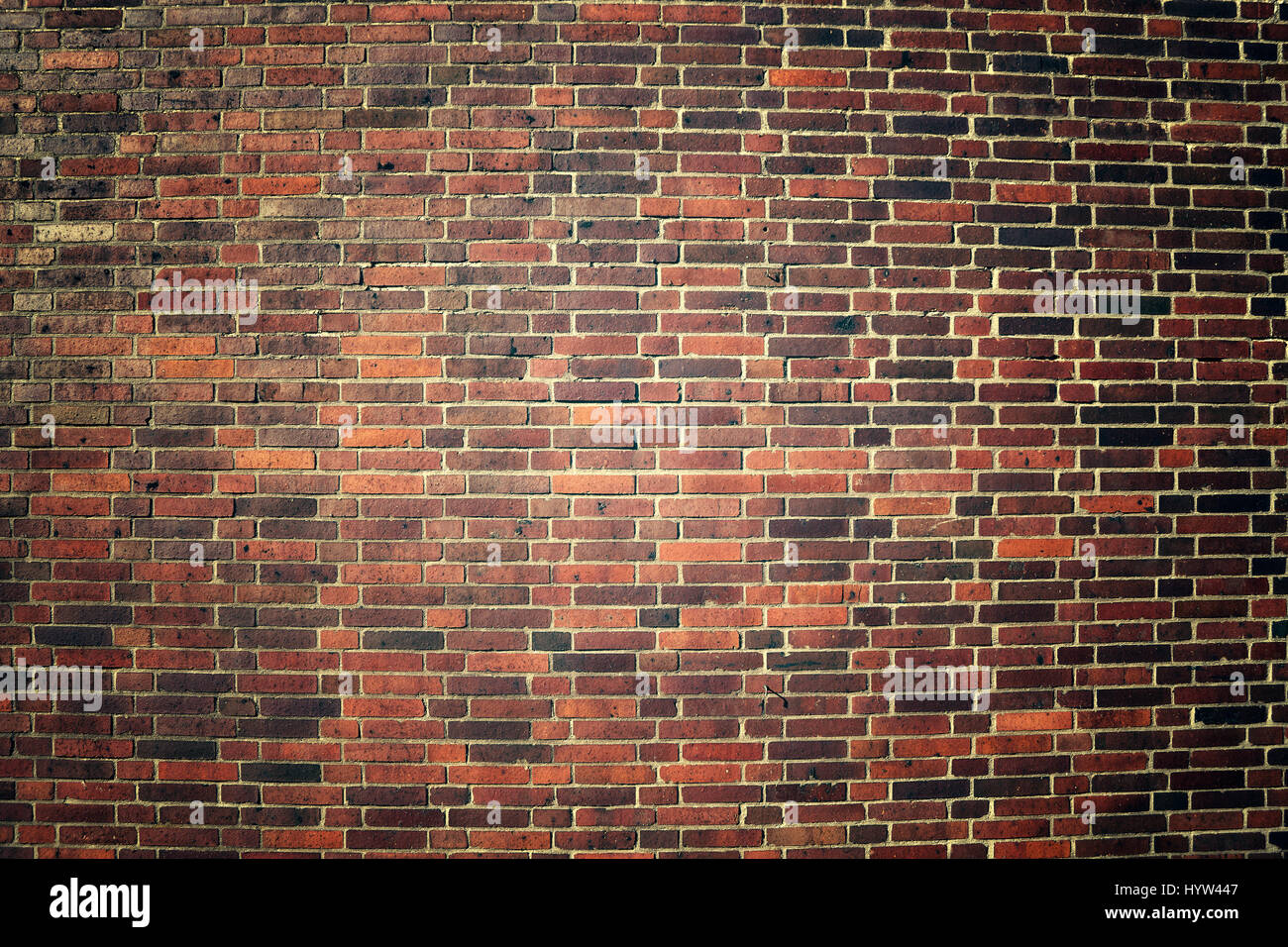 Vintage toned picture of an old weathered clinker brick wall, background or texture. Stock Photo