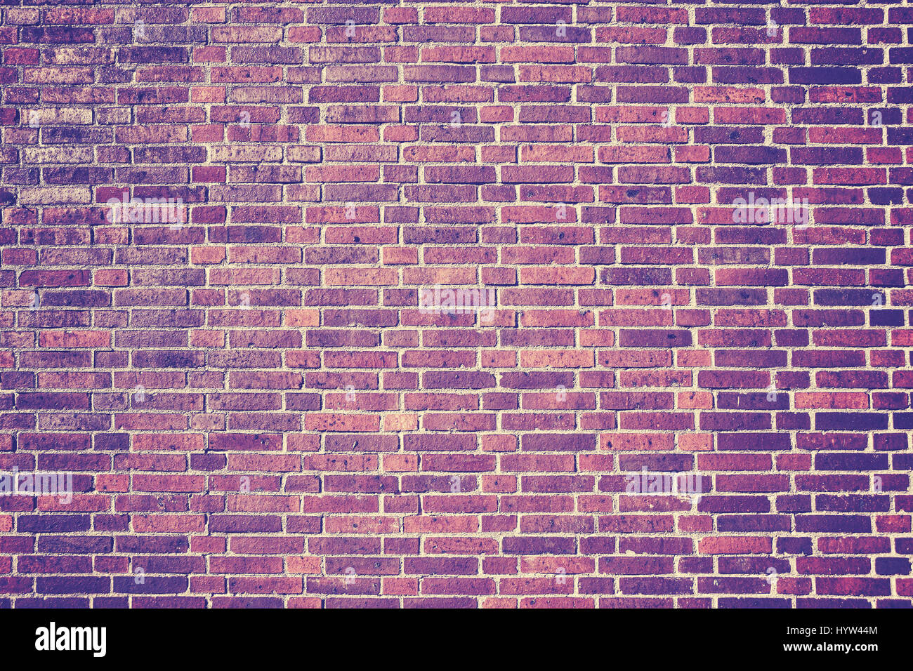 Vintage toned picture of an old weathered brick wall, background or texture. Stock Photo