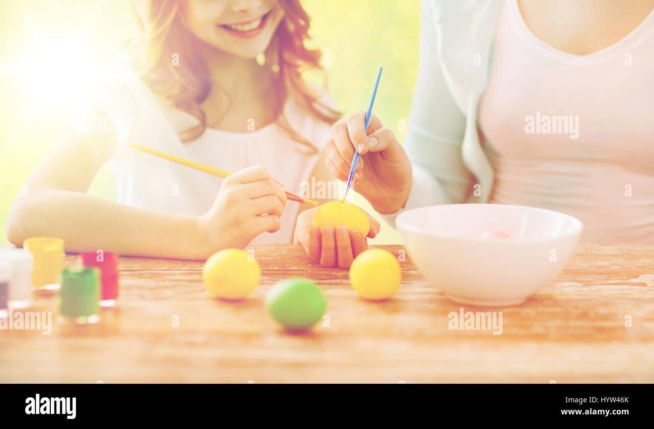 close up of family coloring easter eggs Stock Photo