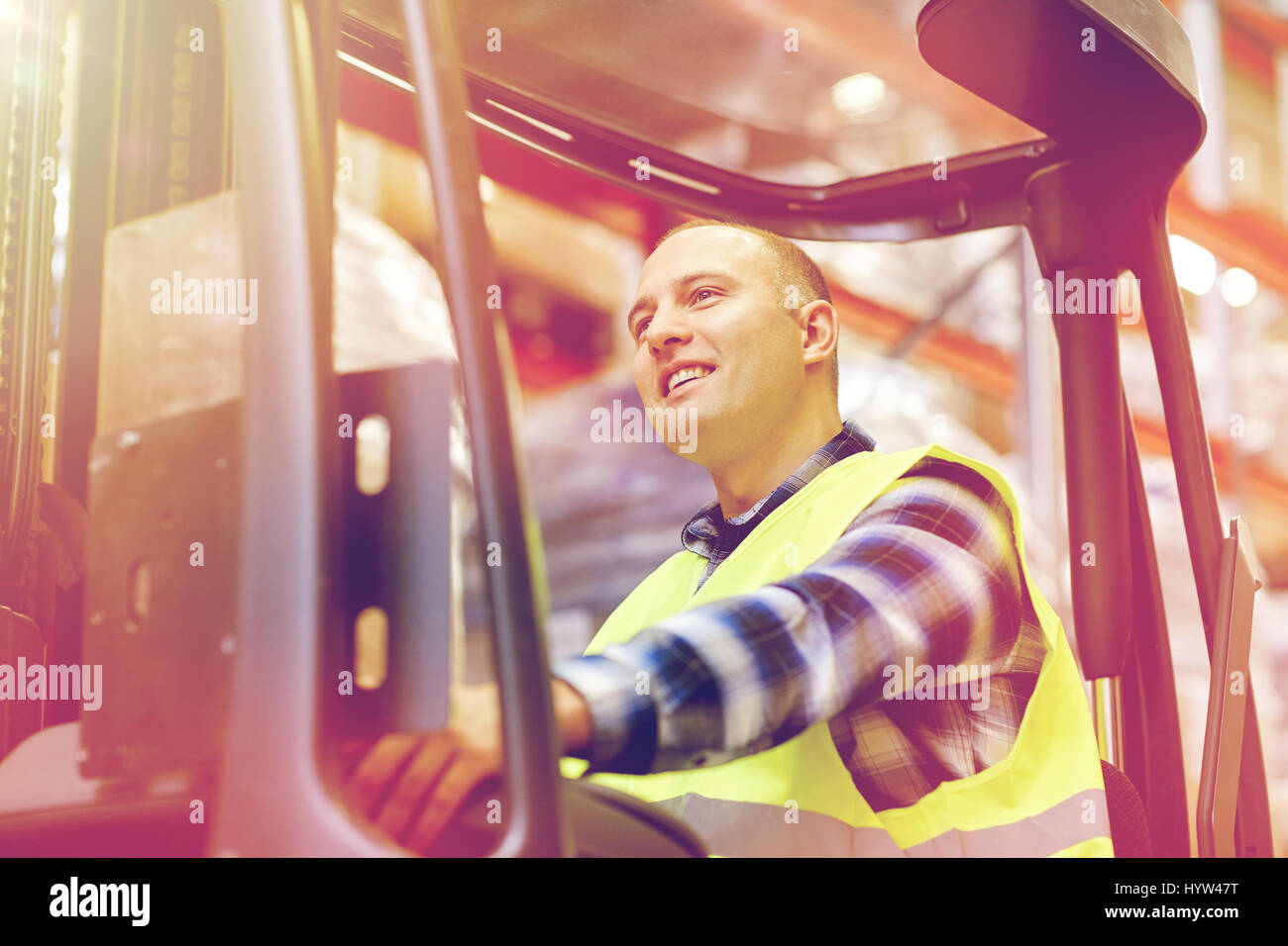man operating forklift loader at warehouse Stock Photo - Alamy