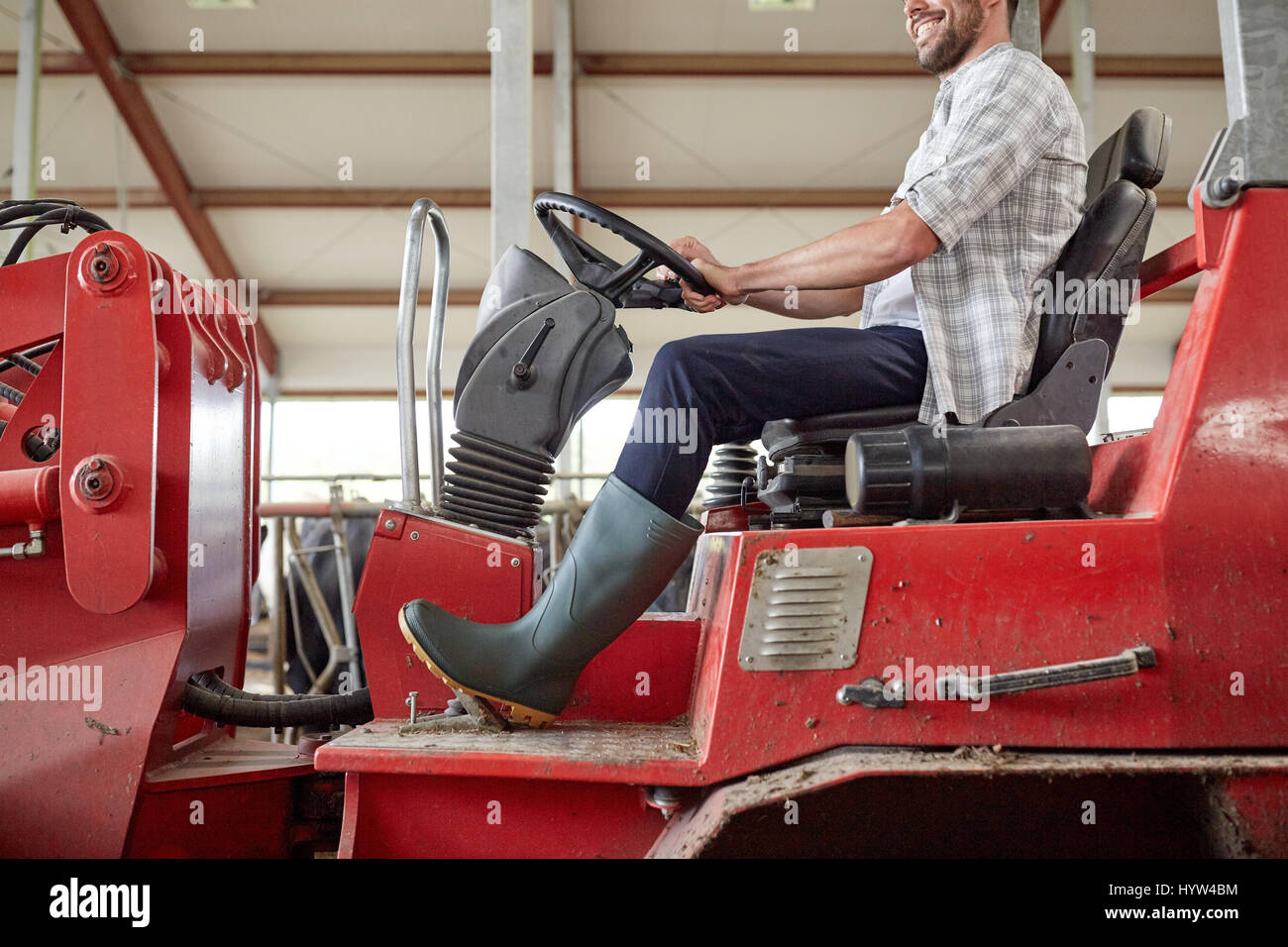 man or farmer driving tractor at farm Stock Photo Alamy